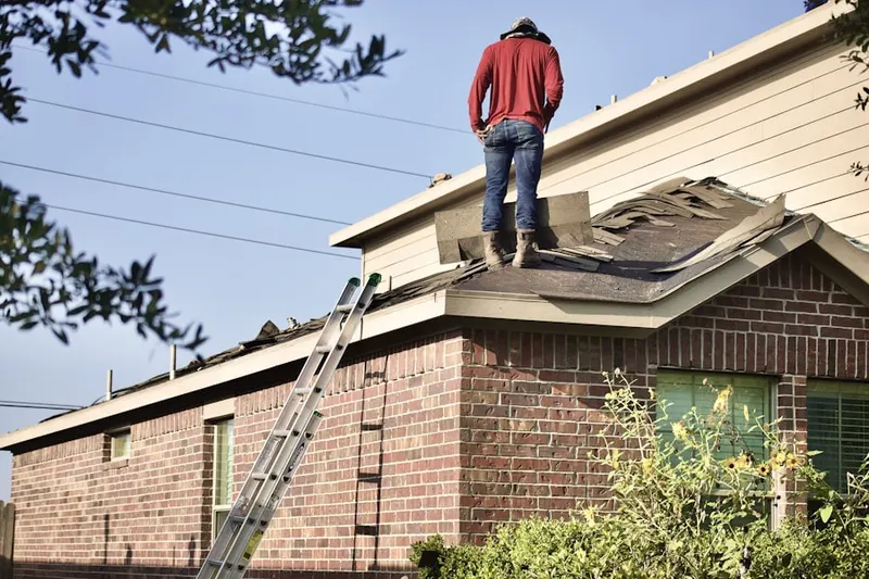 Professional roofer working on a residential roof in Snyderville